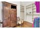 Spacious walk-in closet with custom shelving, drawers and hardwood floors at 450 W Ash St, Zionsville, IN 46077