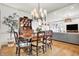 Bright and spacious dining area with a wooden table, decorative hutch, and hardwood floors at 450 W Ash St, Zionsville, IN 46077