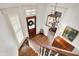 Bright foyer with hardwood floors, stairs, and decorative light fixture creates a grand entry at 450 W Ash St, Zionsville, IN 46077