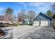 Detached two-car garage with extended driveway, additional sheds, and manicured landscaping at 450 W Ash St, Zionsville, IN 46077