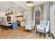 Bright, open kitchen featuring white cabinets, a blue island and cozy seating by the window at 450 W Ash St, Zionsville, IN 46077