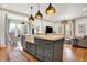 Bright kitchen with a large island, modern appliances, and access to the backyard at 450 W Ash St, Zionsville, IN 46077