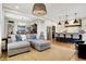 Open-concept living space with a kitchen island, casual seating, and hardwood flooring at 450 W Ash St, Zionsville, IN 46077