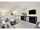 Comfortable living room with a TV, shelving unit, and a kitchenette area at 450 W Ash St, Zionsville, IN 46077