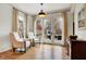 Sunlit living room with hardwood floors and french doors leading to the backyard patio at 450 W Ash St, Zionsville, IN 46077