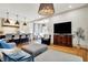 Open concept living area featuring modern lighting, kitchen island and comfortable furniture at 450 W Ash St, Zionsville, IN 46077