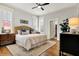 Comfortable main bedroom with hardwood floors, a ceiling fan, and plenty of natural light at 450 W Ash St, Zionsville, IN 46077