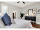 Well-lit main bedroom featuring hardwood floors, a ceiling fan and an ornate dresser at 450 W Ash St, Zionsville, IN 46077