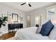 Main bedroom with hardwood floors, a ceiling fan, and view of an ensuite bathroom at 450 W Ash St, Zionsville, IN 46077