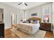 Bright main bedroom featuring large windows with shutters and hardwood floors at 450 W Ash St, Zionsville, IN 46077