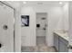 This bathroom features a glass shower, walk-in closet and light grey vanity with sink at 4571 Laughter Ln, Indianapolis, IN 46235