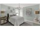 Stylish bedroom features a modern light fixture and cozy ambiance with plenty of natural light at 4571 Laughter Ln, Indianapolis, IN 46235