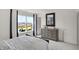 Light-filled bedroom with large windows, stylish dresser, and neutral tones, creating a serene and inviting space at 4571 Laughter Ln, Indianapolis, IN 46235