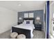 Charming bedroom featuring stylish striped accent wall, complemented by modern furnishings and natural light at 4571 Laughter Ln, Indianapolis, IN 46235