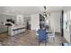 Open-concept kitchen and dining area with stainless steel appliances, a kitchen island, and ample seating at 4571 Laughter Ln, Indianapolis, IN 46235