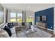 Bright living room featuring a comfortable sectional sofa, large windows, and a stylish entertainment center at 4571 Laughter Ln, Indianapolis, IN 46235