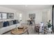 Cozy living room with a comfortable sofa, a desk area, and ample natural light from large windows at 4571 Laughter Ln, Indianapolis, IN 46235