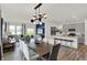 Open-concept space showcasing a dining table, living room, and kitchen island in a brightly lit area at 4571 Laughter Ln, Indianapolis, IN 46235