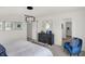 This bedroom features a view of a walk-in closet, contemporary light fixture, and a blue accent chair at 4571 Laughter Ln, Indianapolis, IN 46235