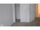 Bedroom featuring neutral carpet, white walls, a closet, and adjacent room access at 5138 Modernist Blvd, Indianapolis, IN 46237