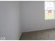 Bedroom features neutral carpet, white walls, trim, and a window with a view of the yard at 5138 Modernist Blvd, Indianapolis, IN 46237