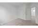 Carpeted bedroom with white walls, closet with folding doors, and doorway to adjacent space at 5138 Modernist Blvd, Indianapolis, IN 46237