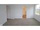 Bedroom featuring neutral carpet, white walls, and doorway leading to a bright bathroom at 5138 Modernist Blvd, Indianapolis, IN 46237