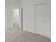 Carpeted bedroom with closets featuring mirrored sliding doors and a view into the hallway at 5138 Modernist Blvd, Indianapolis, IN 46237