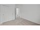 Carpeted bedroom with bi-fold closet doors, a ceiling light, and a doorway to another room at 5138 Modernist Blvd, Indianapolis, IN 46237
