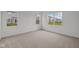 Carpeted bedroom with view of the neighborhood from three windows, providing ample natural light at 5138 Modernist Blvd, Indianapolis, IN 46237