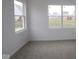 Bright bedroom features neutral carpet, white walls, and multiple windows providing natural light at 5138 Modernist Blvd, Indianapolis, IN 46237