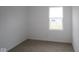 Bright bedroom features neutral carpet, white walls and trim, and a sunlit window at 5138 Modernist Blvd, Indianapolis, IN 46237