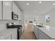 Modern kitchen with white cabinets, stainless steel appliances and center island at 5138 Modernist Blvd, Indianapolis, IN 46237