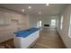 Bright, modern kitchen features a central island with sink and ample white cabinetry at 5138 Modernist Blvd, Indianapolis, IN 46237