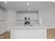 Contemporary kitchen featuring stainless steel appliances, white cabinetry and quartz countertops at 5138 Modernist Blvd, Indianapolis, IN 46237