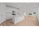 Bright, open kitchen with white cabinetry, a kitchen island and stainless steel appliances at 5138 Modernist Blvd, Indianapolis, IN 46237