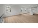 Expansive living room with wood flooring, open layout, and a glimpse of a modern kitchen at 5138 Modernist Blvd, Indianapolis, IN 46237