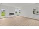 Cozy living room featuring wood floors, a modern fireplace, and natural light at 5138 Modernist Blvd, Indianapolis, IN 46237