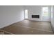Bright living room with a modern electric fireplace and a door leading to the backyard at 5138 Modernist Blvd, Indianapolis, IN 46237