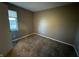 Neutral bedroom featuring cozy carpet and a window that provides natural light at 5730 Pemberly Dr, Indianapolis, IN 46221