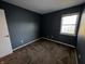 Neutral bedroom featuring cozy carpet and a window that provides natural light at 5730 Pemberly Dr, Indianapolis, IN 46221