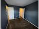 Neutral bedroom featuring cozy carpet and access to the hallway and closet at 5730 Pemberly Dr, Indianapolis, IN 46221