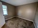 Neutral bedroom featuring cozy carpet and a window that provides natural light at 5730 Pemberly Dr, Indianapolis, IN 46221