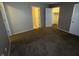 Neutral bedroom featuring cozy carpet and access to closet and en suite bath at 5730 Pemberly Dr, Indianapolis, IN 46221