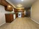Kitchen area with wood cabinets, white appliances, and tiled floors at 5730 Pemberly Dr, Indianapolis, IN 46221