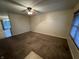 Spacious living room with carpet flooring, overhead lighting, and neutral paint at 5730 Pemberly Dr, Indianapolis, IN 46221