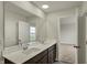Modern bathroom featuring double vanity sinks with a large mirror and bright, neutral finishes at 5777 Greenbrier Ct, Brownsburg, IN 46112
