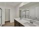 Bathroom featuring double vanities, a large mirror, and a glass-enclosed shower at 5777 Greenbrier Ct, Brownsburg, IN 46112