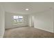 Bedroom with neutral walls, carpeting, and a window that allows natural light to brighten the space at 5777 Greenbrier Ct, Brownsburg, IN 46112