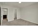 Spacious bedroom with neutral walls, carpet floors and two open doorways to adjacent rooms at 5777 Greenbrier Ct, Brownsburg, IN 46112